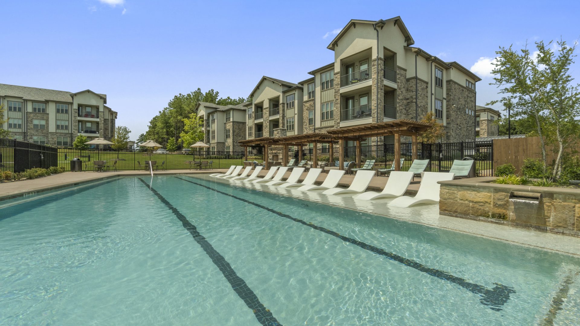 Apartments for rent in Tyler, TX. Resort Style Swimming pool with lounge area and cabanas.